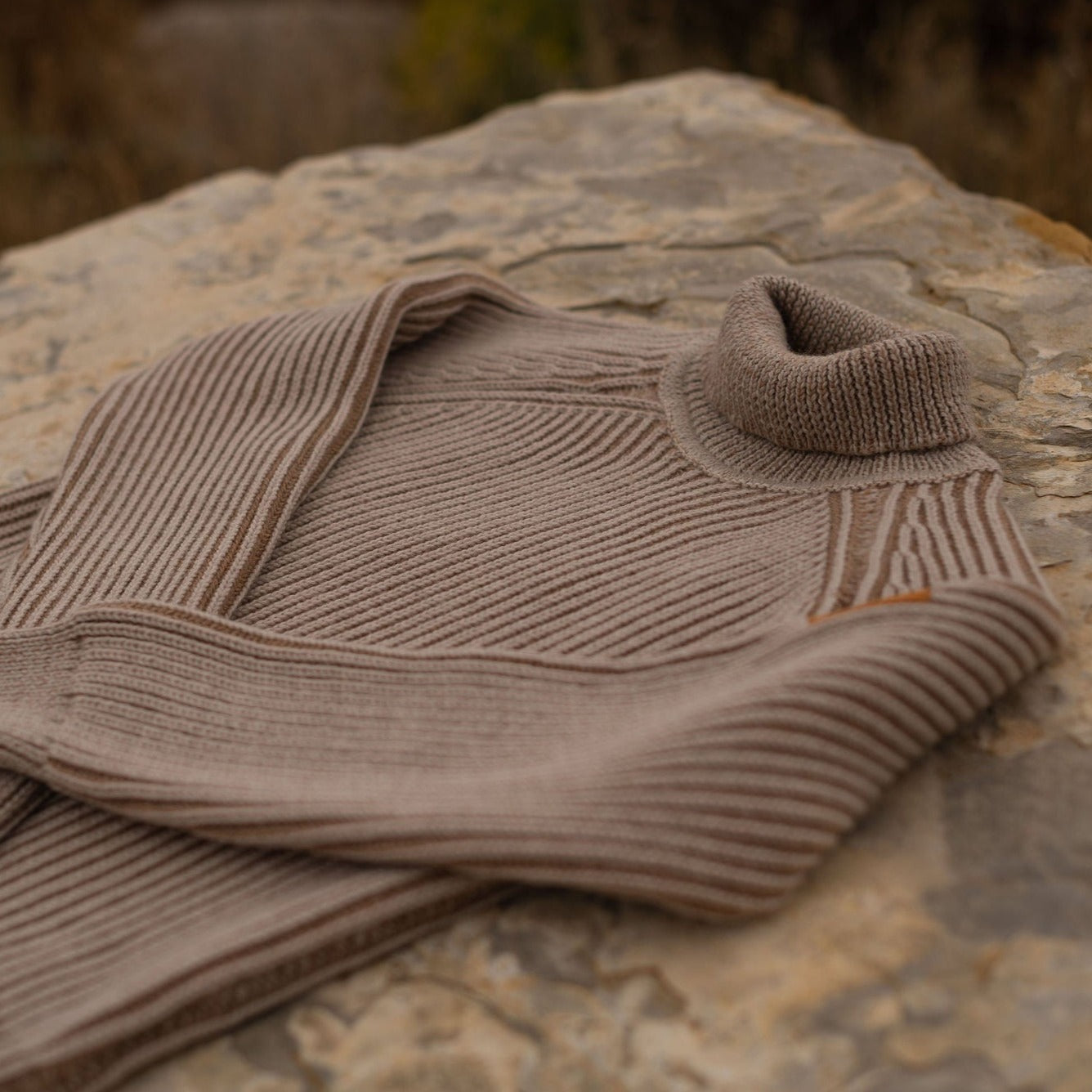 The Mesa Merino Wool Sweater is soft and cozy, crafted in a slightly boxy cropped silhouette.  The two-toned fisherman rib design adds unique texture and style     Details  100% merino wool  Cropped fit  Turtleneck  Raglan sleeve  Ribbed cuff  Made in the USA