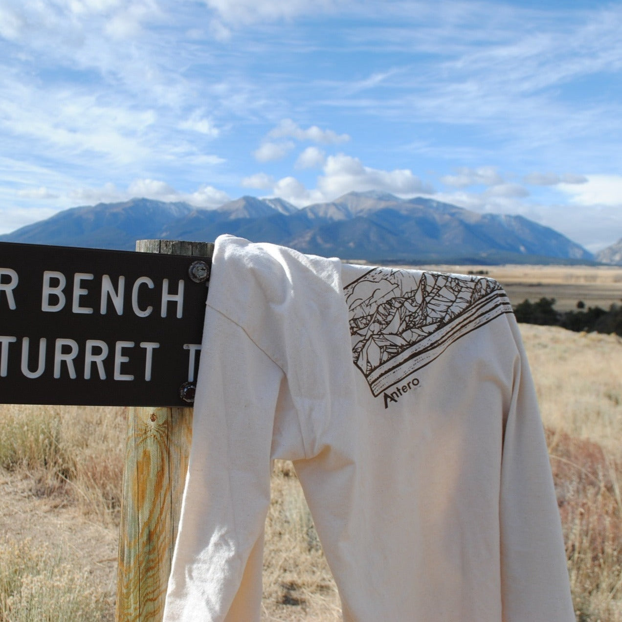 100% Organic Cotton Color | Natural Crew Neck Ribbed cuff Made in the USA Features artwork by local Salida CO artist Brinkley Messick