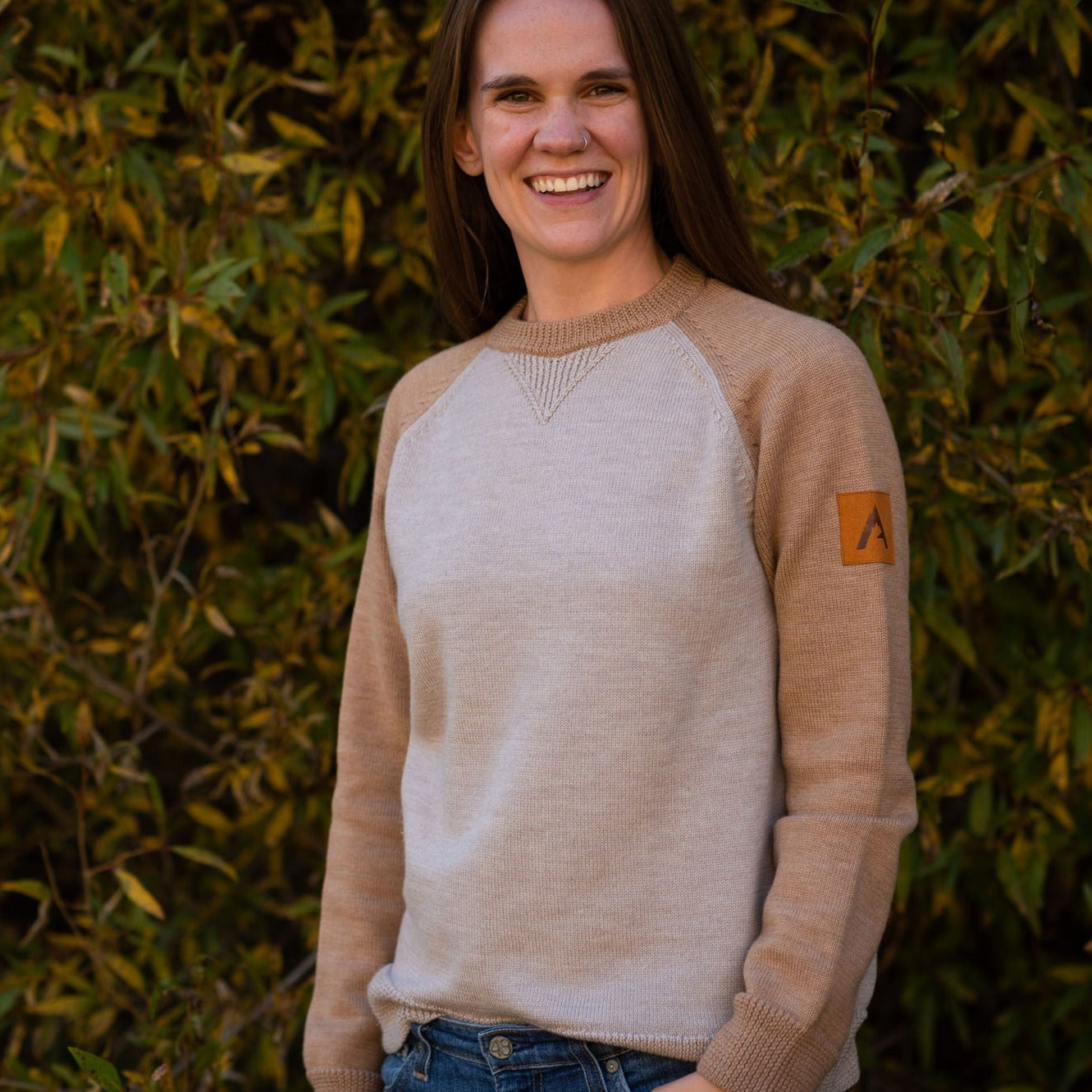 A comfortable classic in soft merino wool.  Knitted in the United States with fine Italian merino wool yarn.  The Colorado Sweater is sized unisex     Details  Made in the United States  100% merino wool  Classic fit / high crew neck  Contrast color raglan sleeve  2 colors:  sand/tan, olive/taupe  Unisex sizing