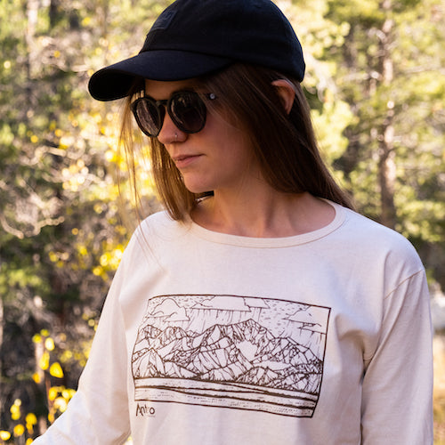 100% Organic Cotton   Color | Natural  Slightly Scooped Neck  Made in the USA   Features artwork by local Salida CO artist Brinkley Messick